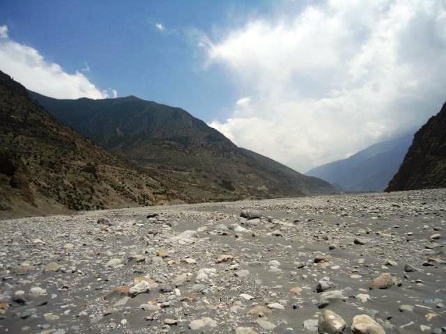 Riding on dried riverbed, off-road trail Nepal Mustang