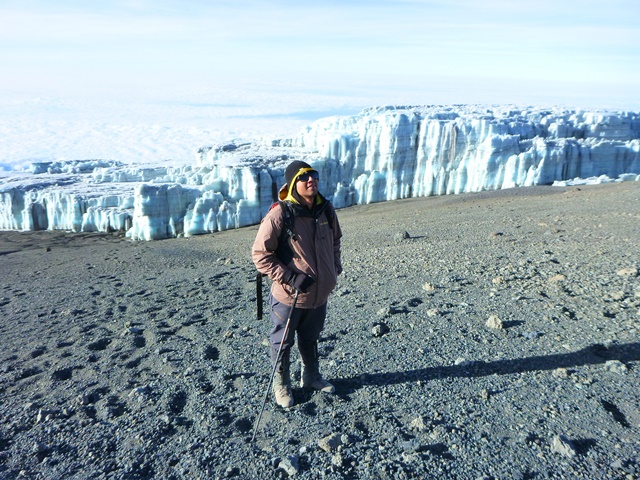 At the summit of Mount Kilimanjaro — above the clouds, nearly 6,000 meters high.