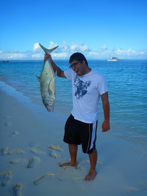 Fisherman on white sand beach Zanzibar